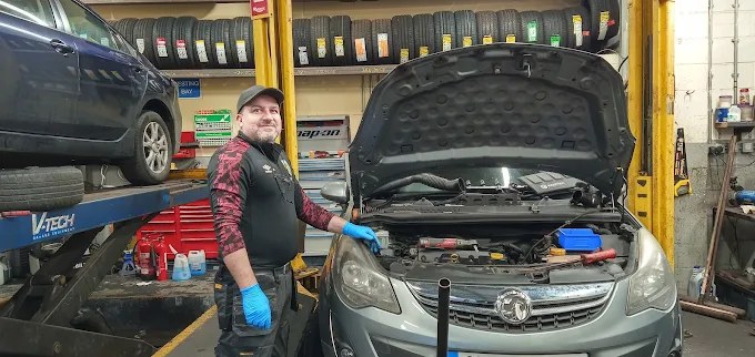 Forge technician working on a vehicle in the Burnley workshop
